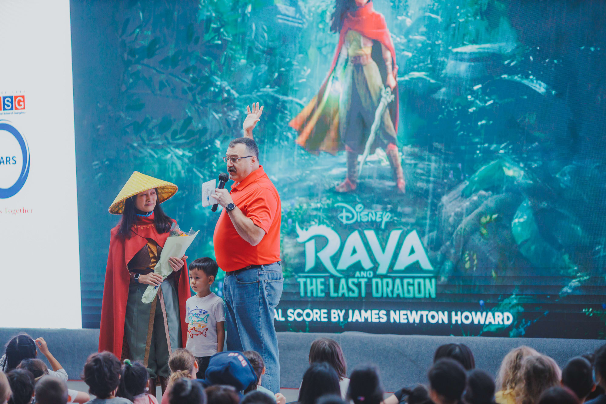 AISG Family Fun Day for SY2122 with director introducing the movie with a person in raya costume