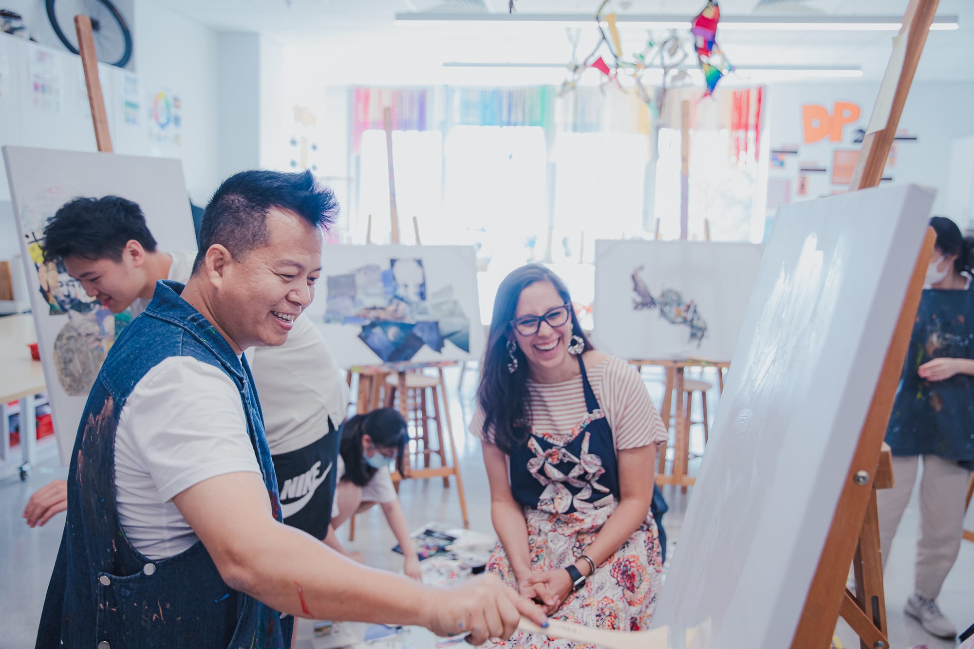 laughing as artist works on portrait