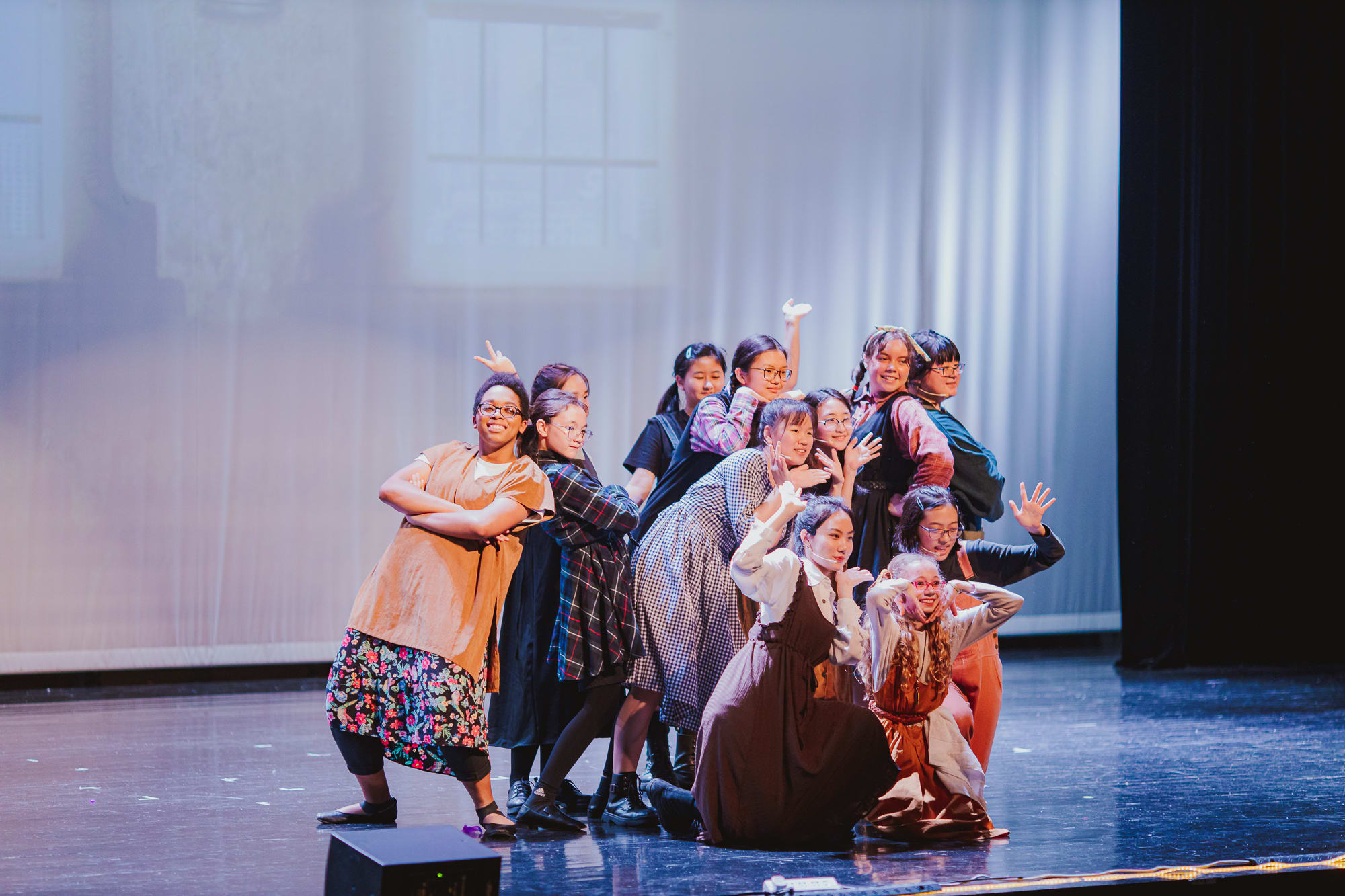 photo of students on stage acting as orphans in annie jr