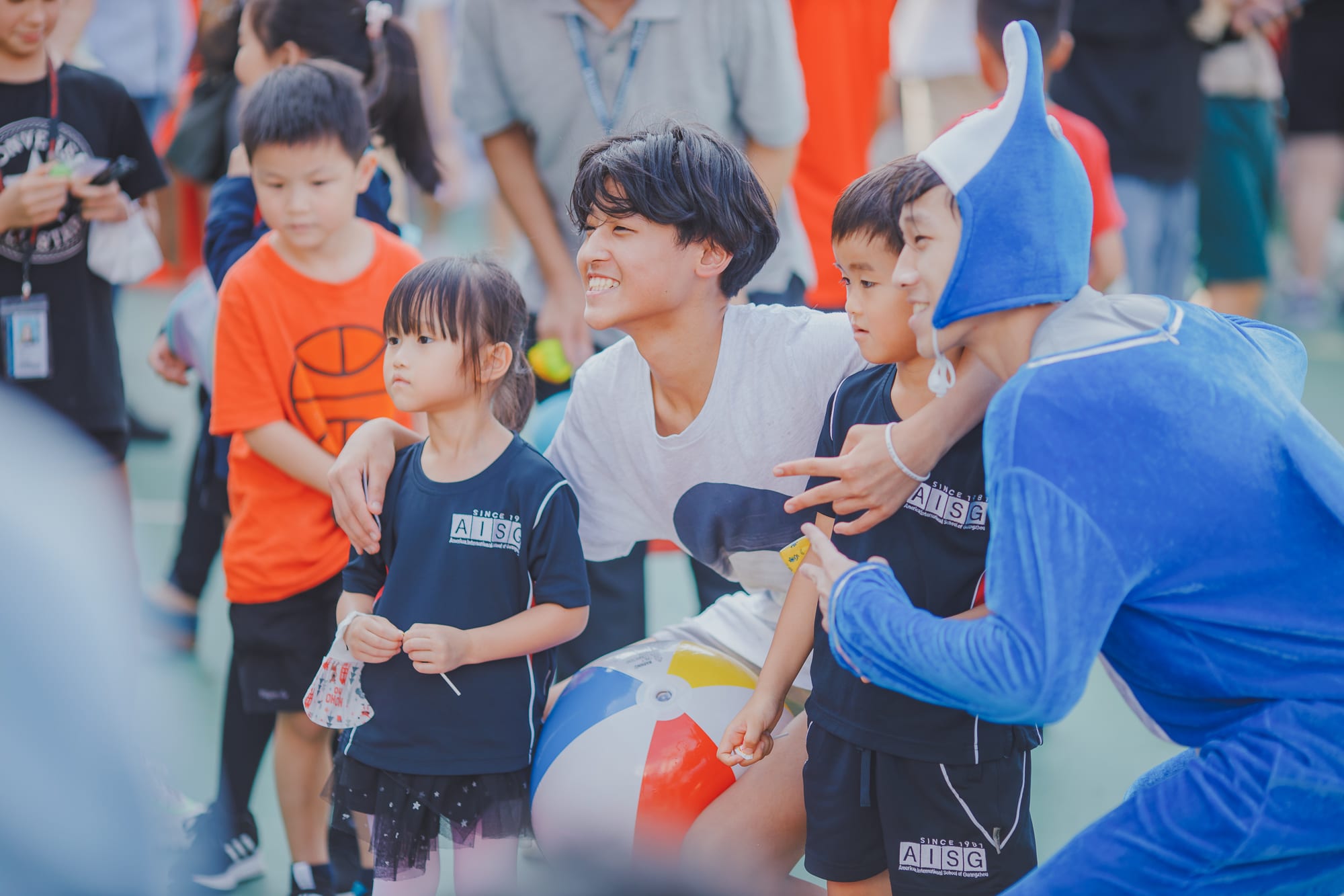 AISG Family Fun Day for SY2122 with elementary students taking a photo with upper secondary in costumes
