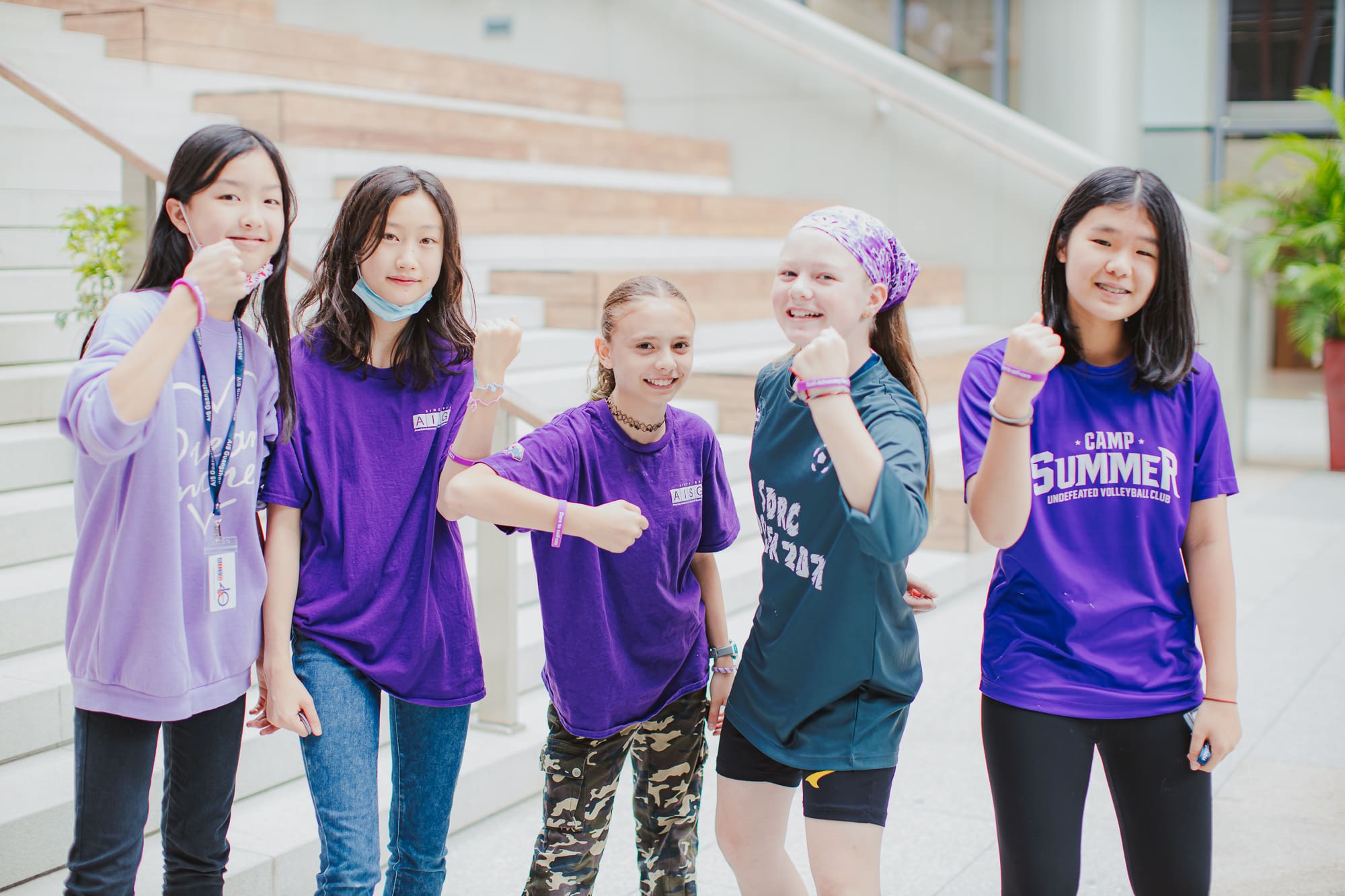 Secondary female students wearing purple for AISG Child Protection Awareness Month