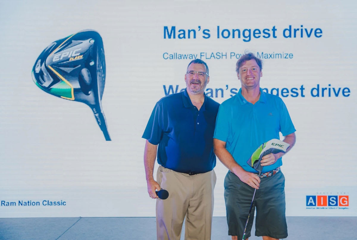kevin baker is congratulating the man who had the longest drive in the golf classic