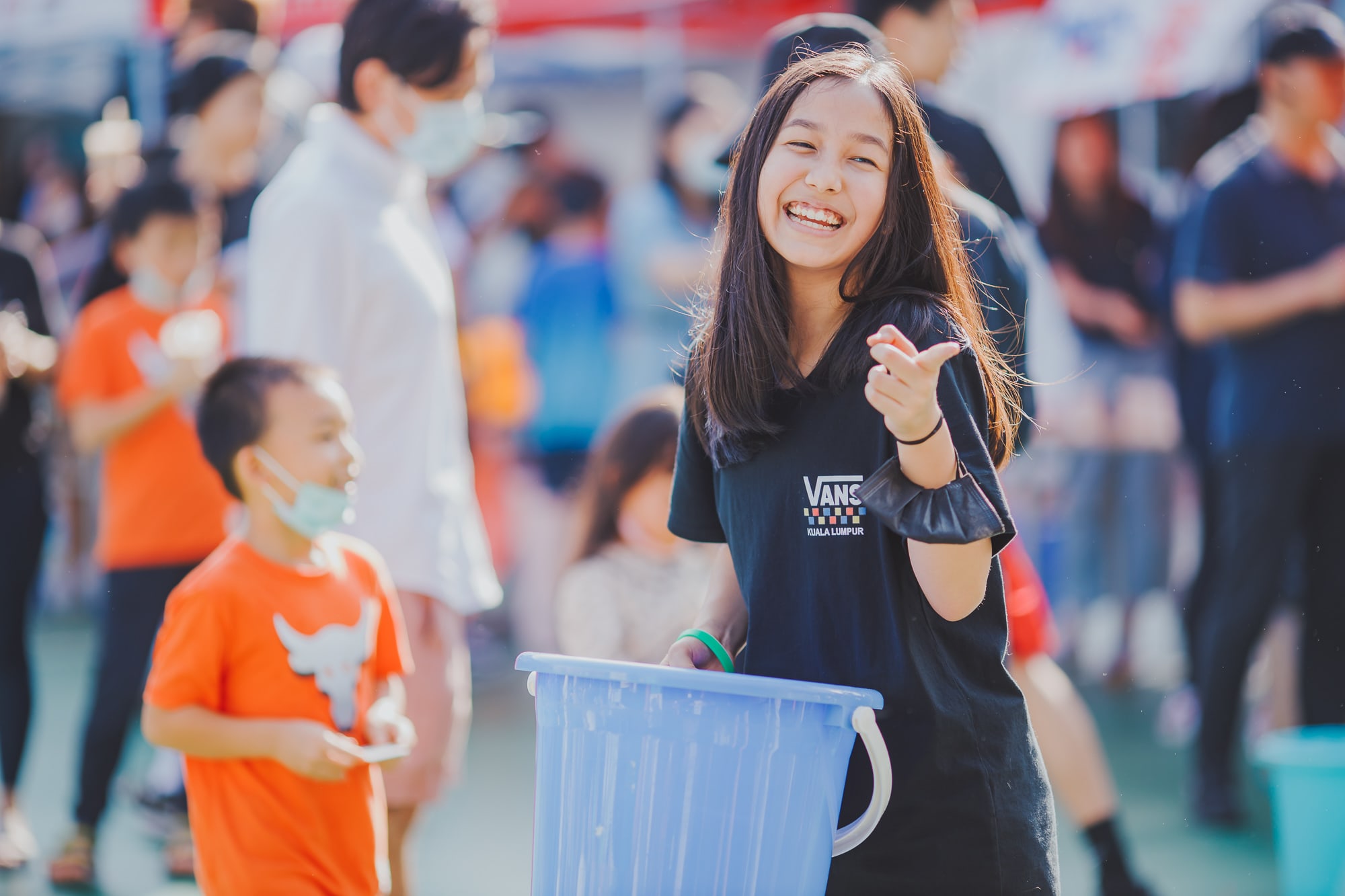 AISG Family Fun Day for SY2122 with secondary student smiling with bucket