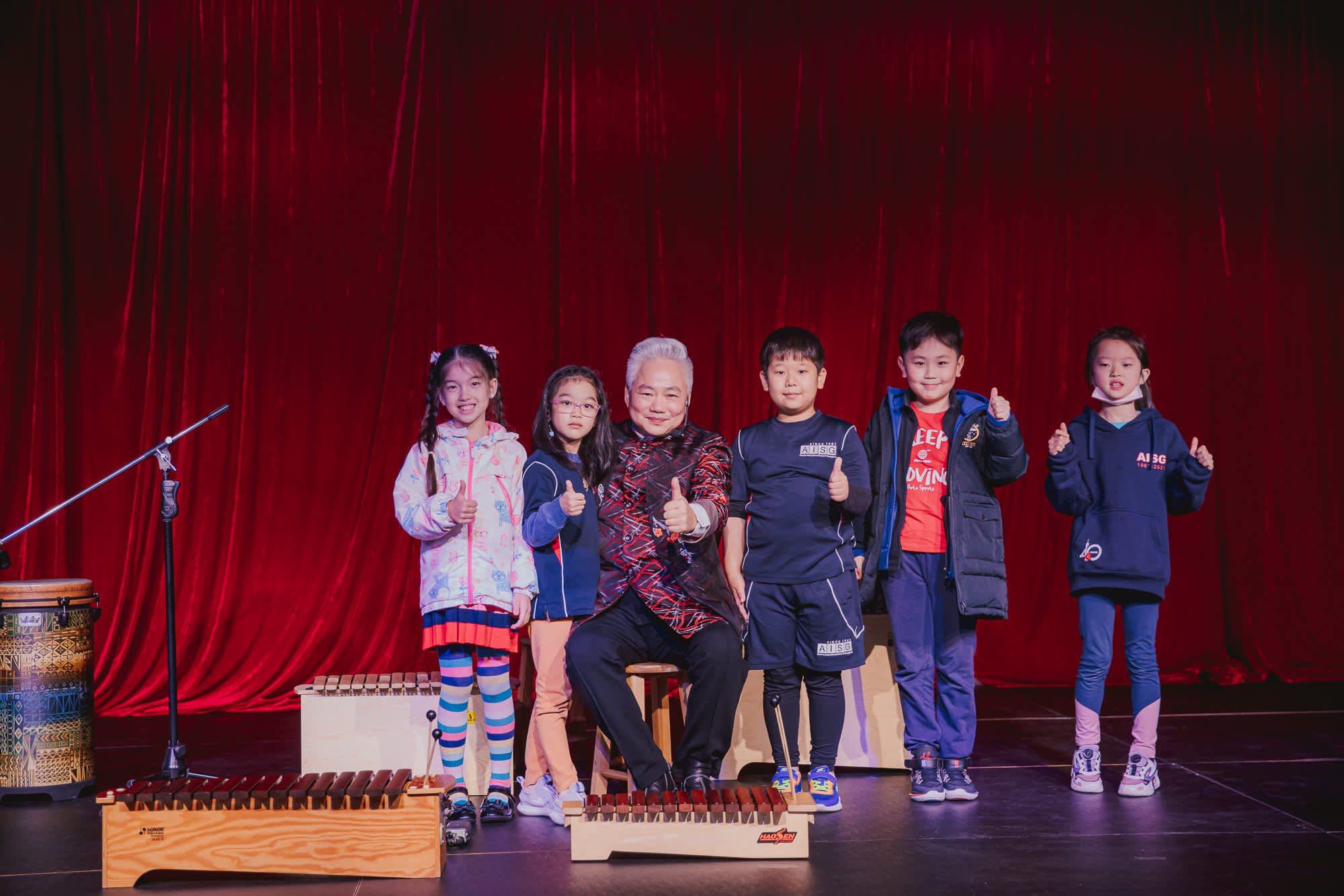 AISG Speaker Series with Fang Jinlong with elementary students on stage