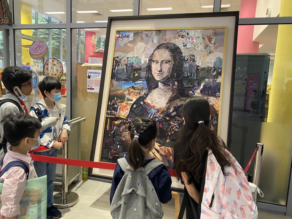 students looking at collage art