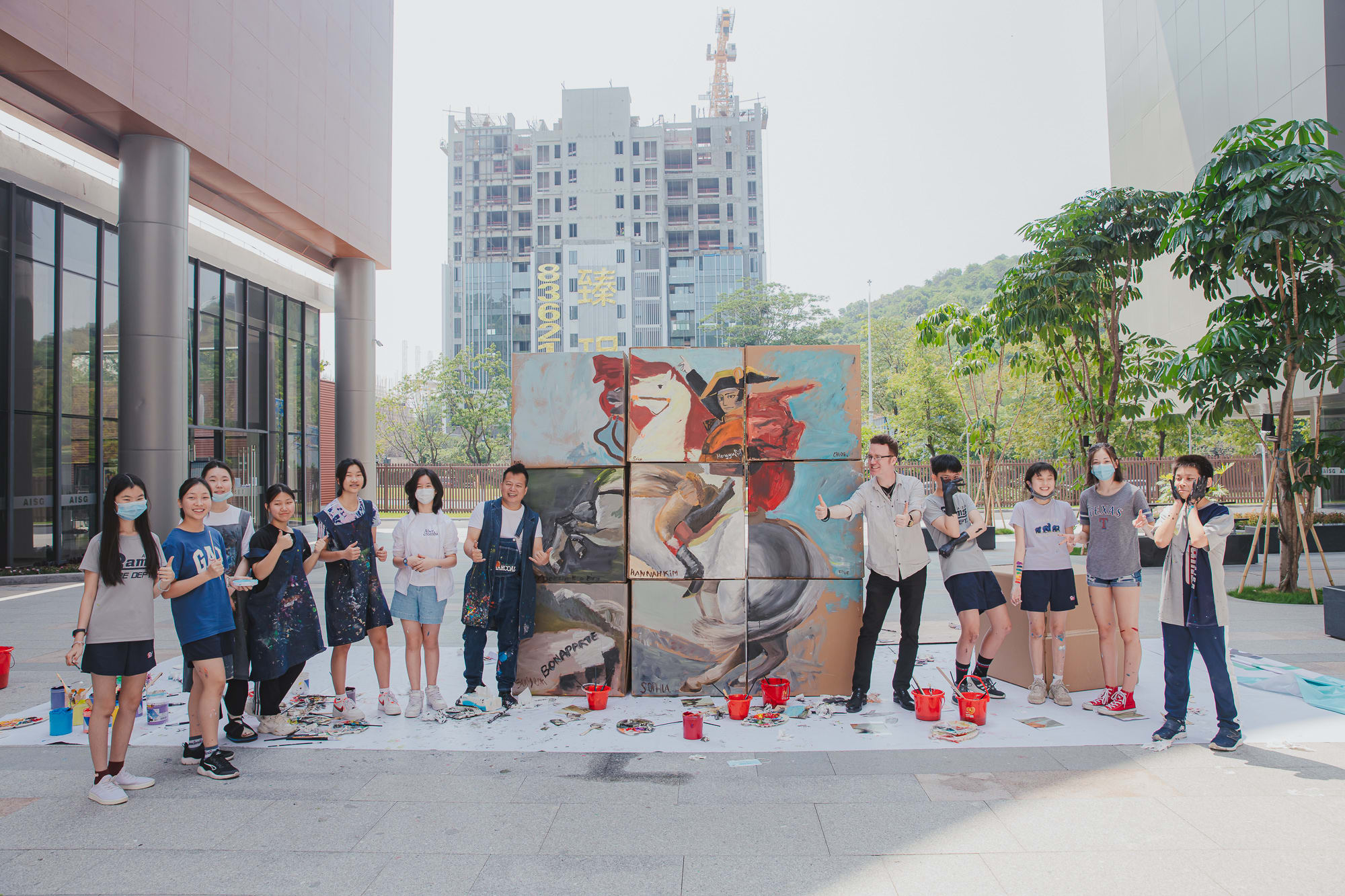 students posing with painted cardboard boxes