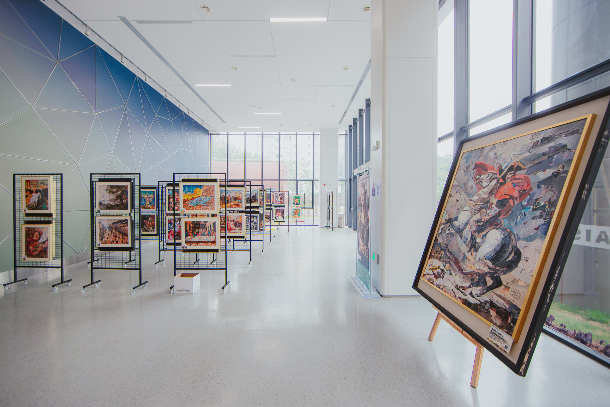 paintings displayed in a glass room
