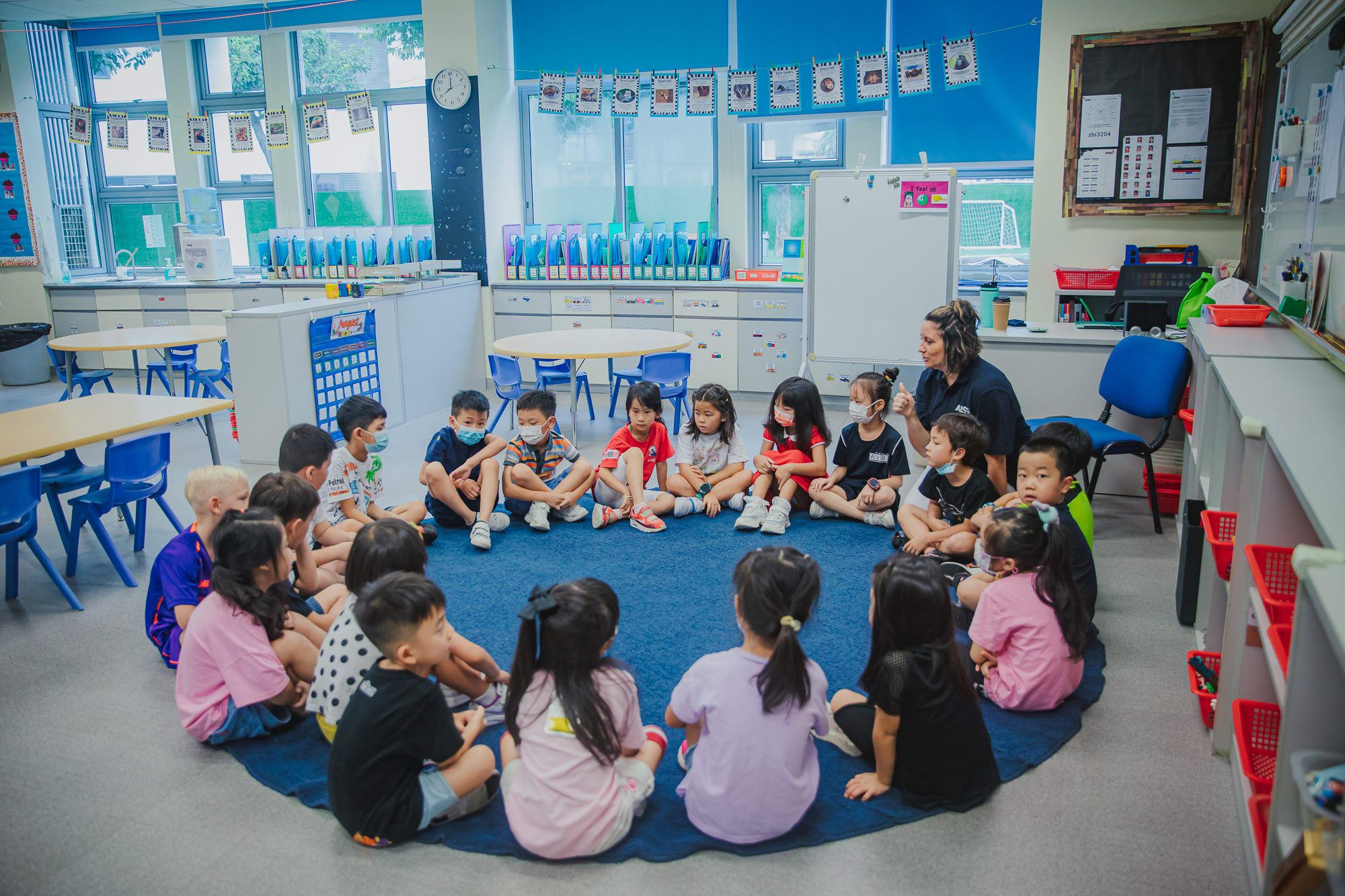 AISG Elementary School class with teacher all sitting in a circle