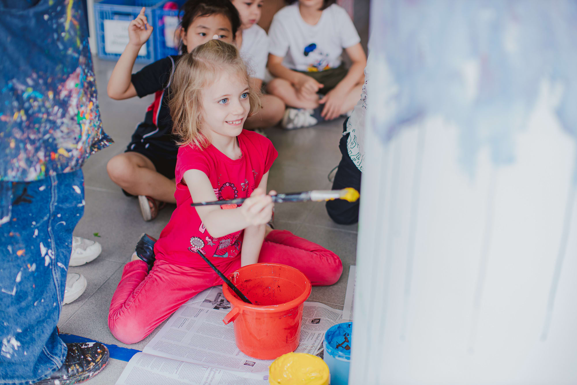 young girl paints pillar
