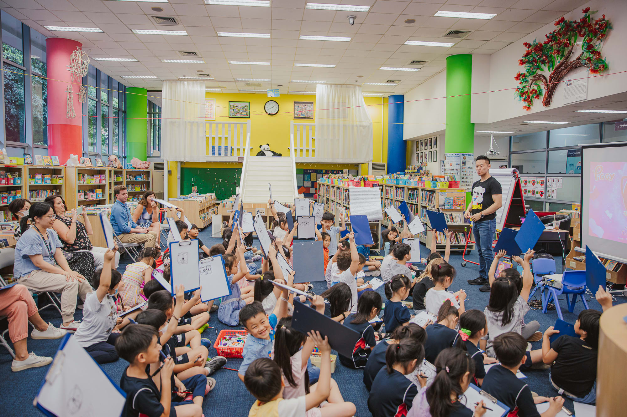 students waving pads in the air