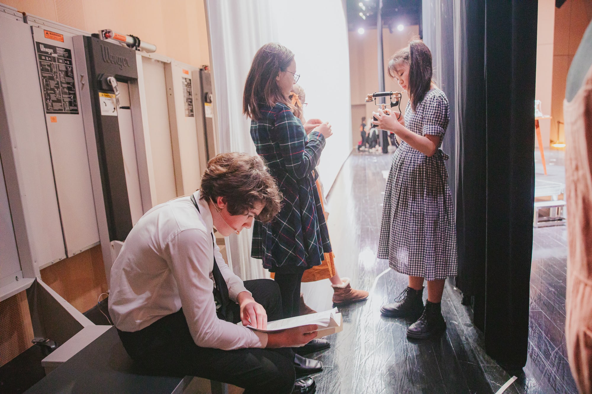 students backstage learning lines and preparing for the show