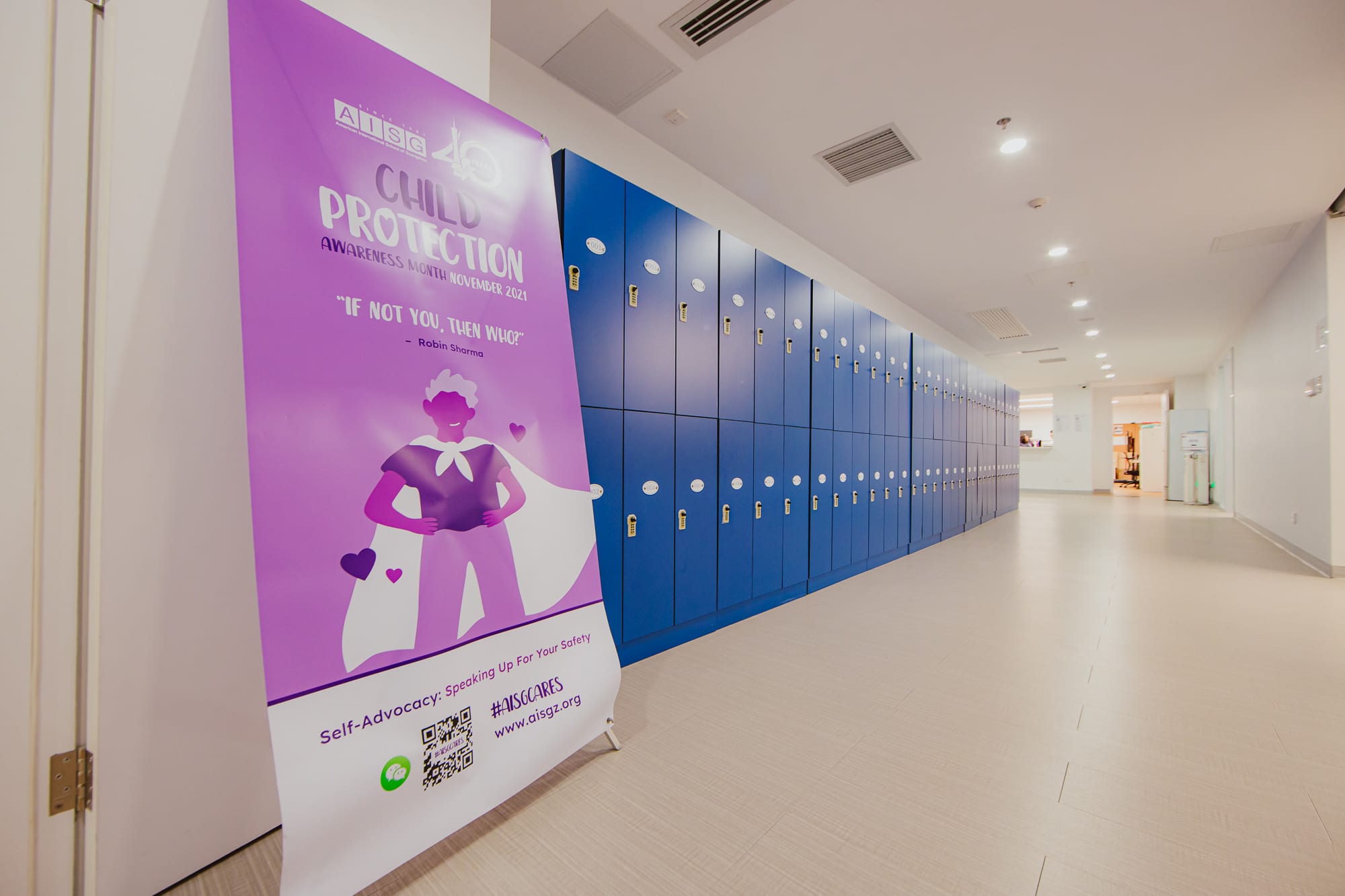Picture of child protection banner along the hallway for AISG Child Protection Awareness Month