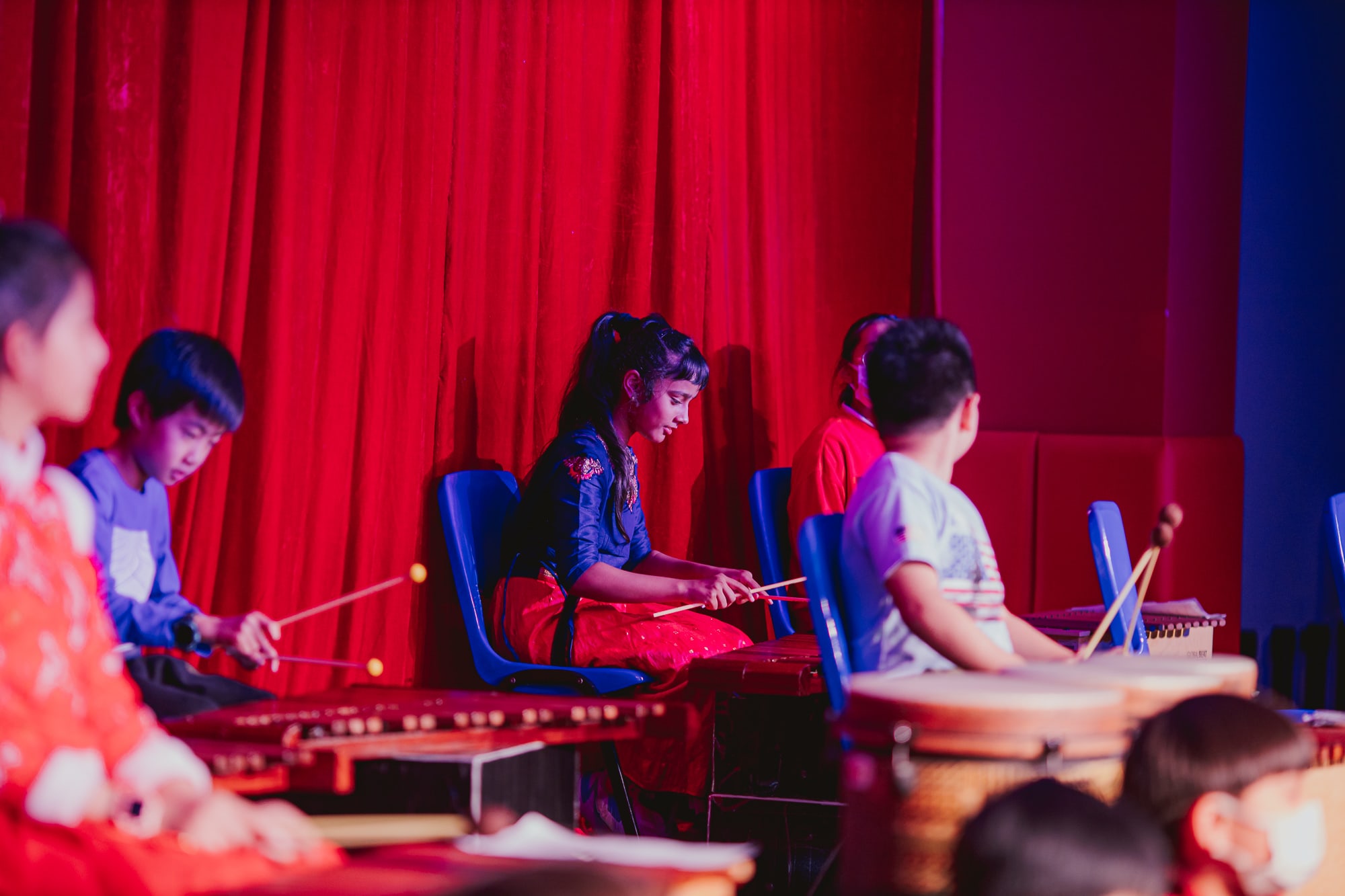 AISG elementary school students playing instruments in a performance