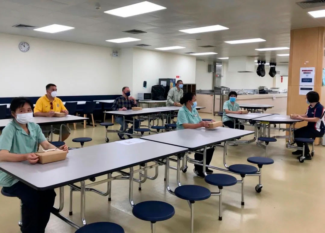 picture showing staff demonstrating social distancing in the lunchroom