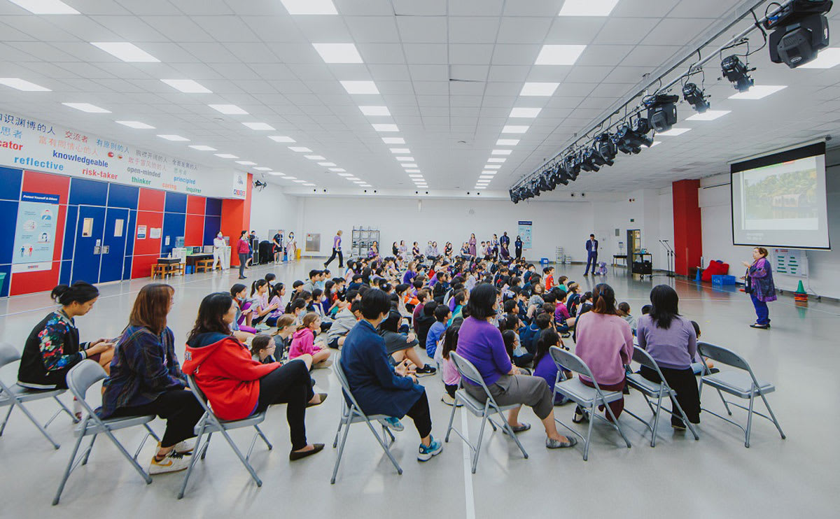 students sitting on the floor listening to a program about keeping safe