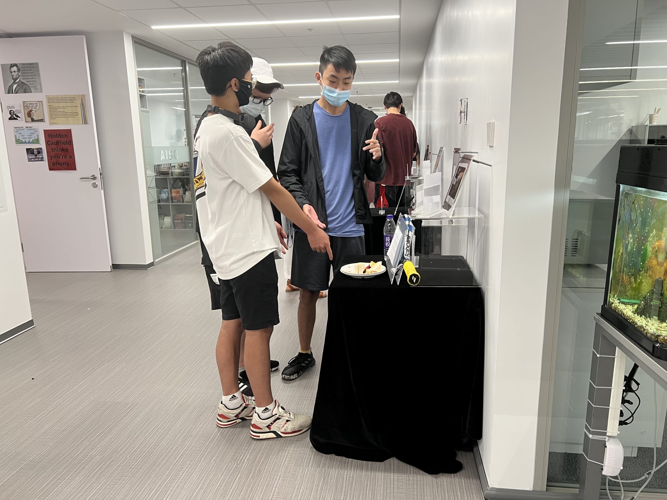 AISG TOK Exhibition with a student presenting his research to others