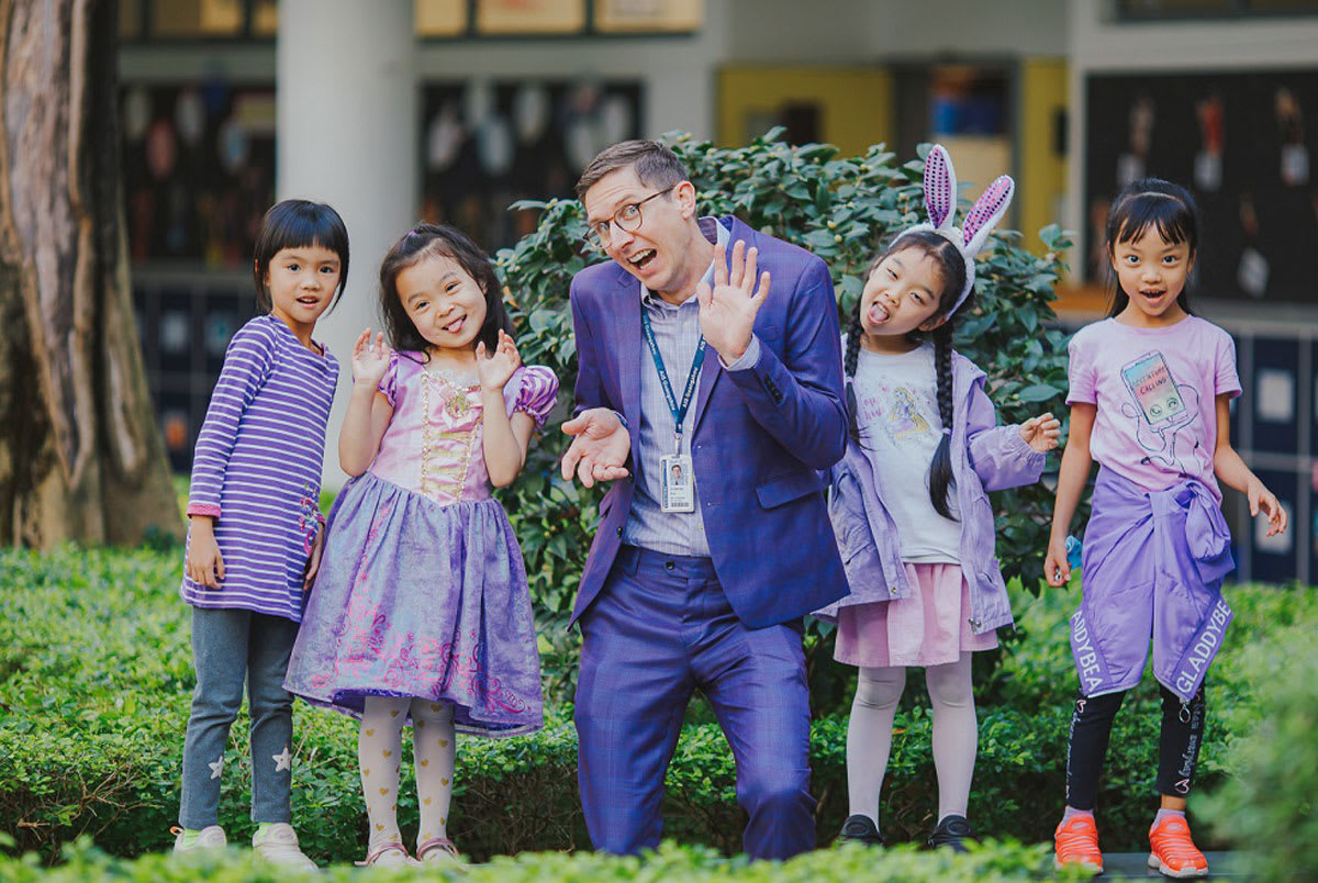 4 little girls making faces with an adult 