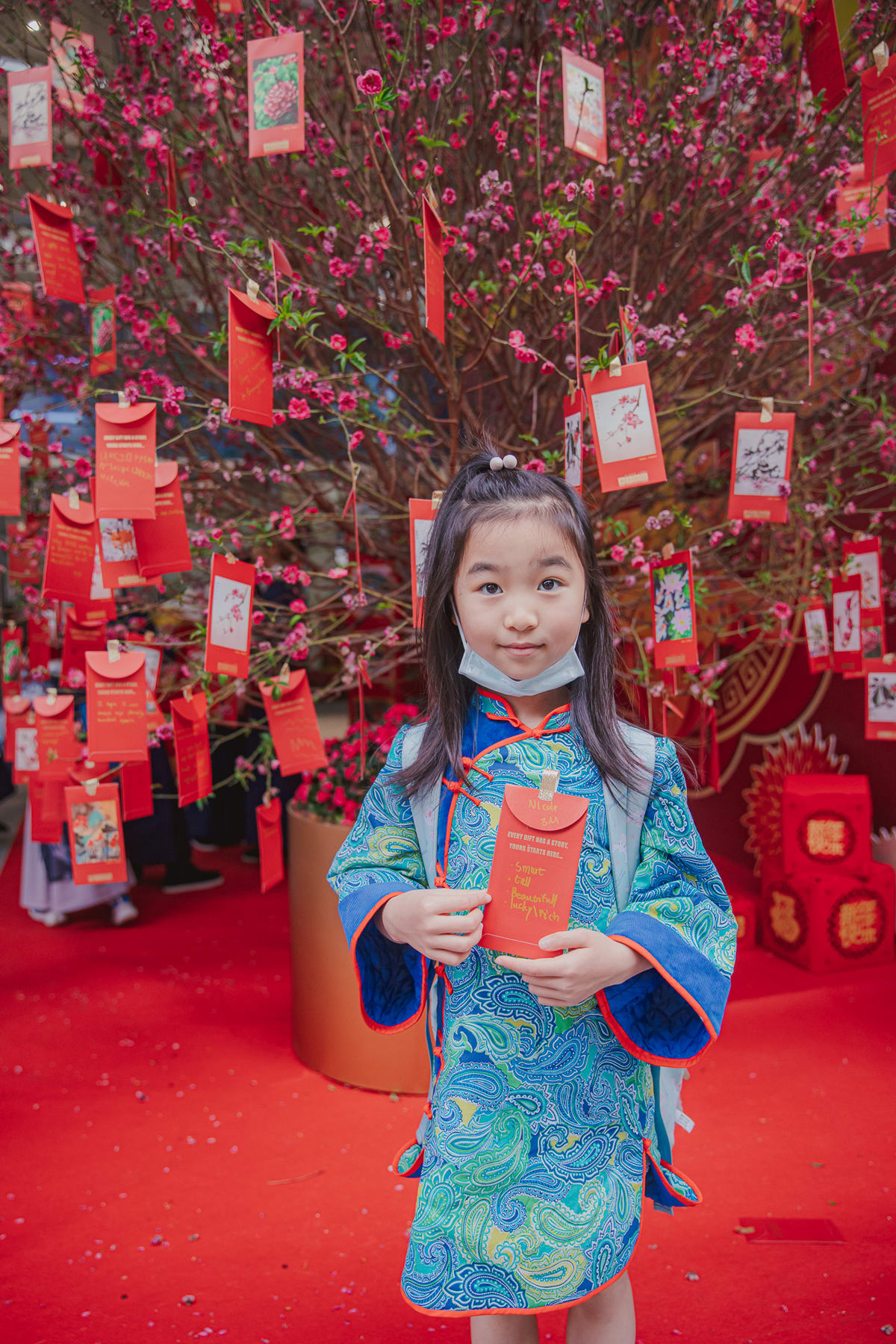 a girl shows her self designed envelope for giving