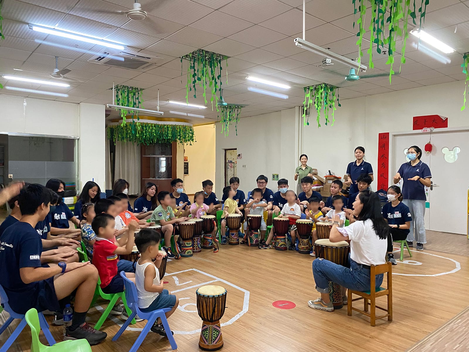 AISG students play african drum with autistic kids