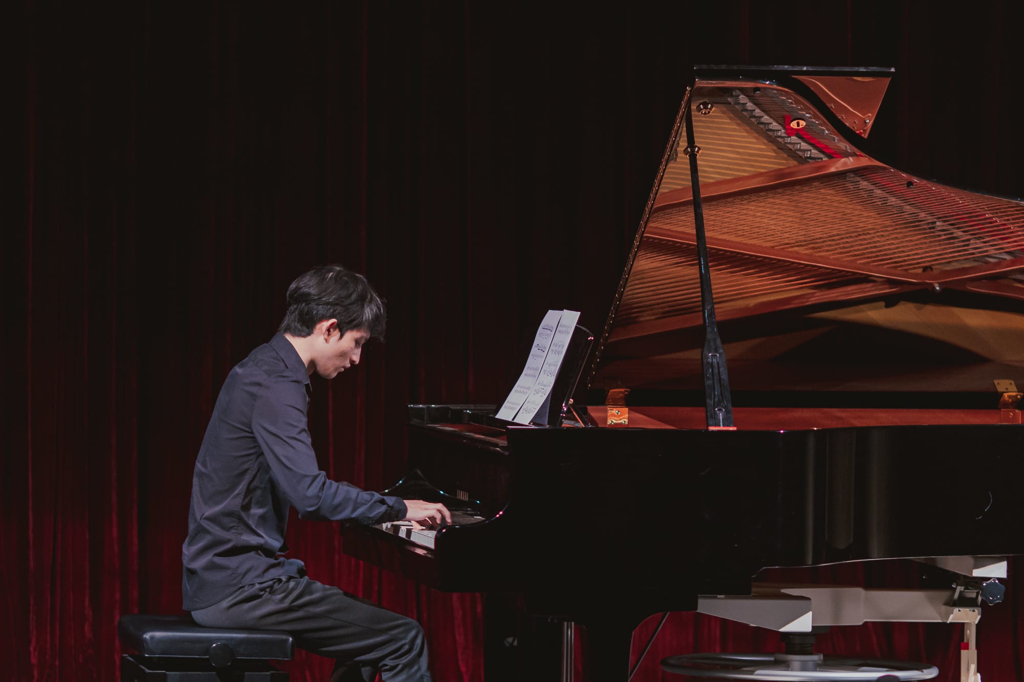 An AISG senior student playing the piano for the International Baccalaureate (IB) Music Recital