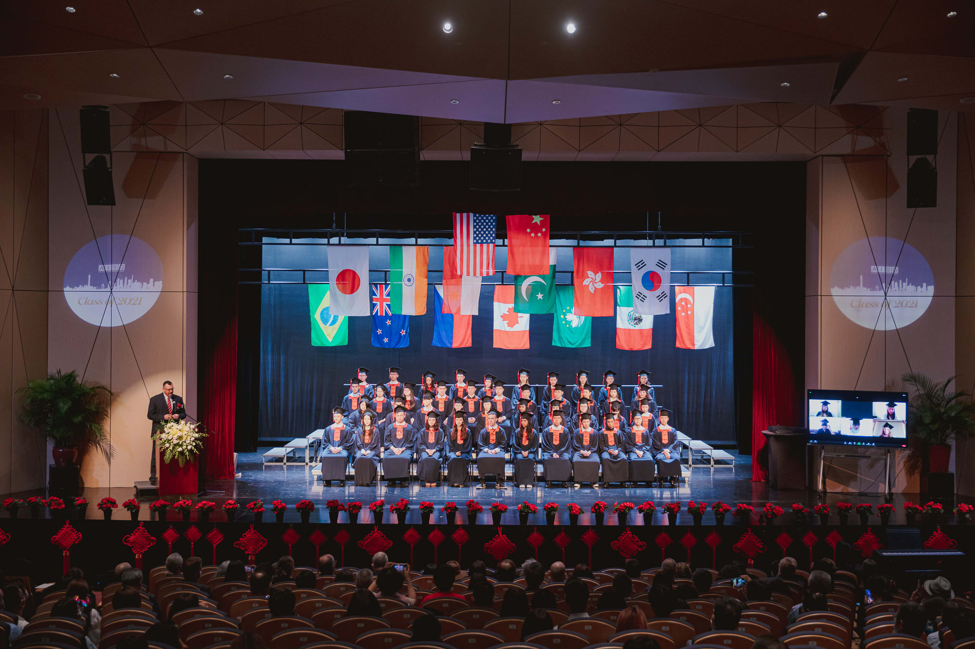 2021 AISG Seniors in their cap and gown at stage and virtually