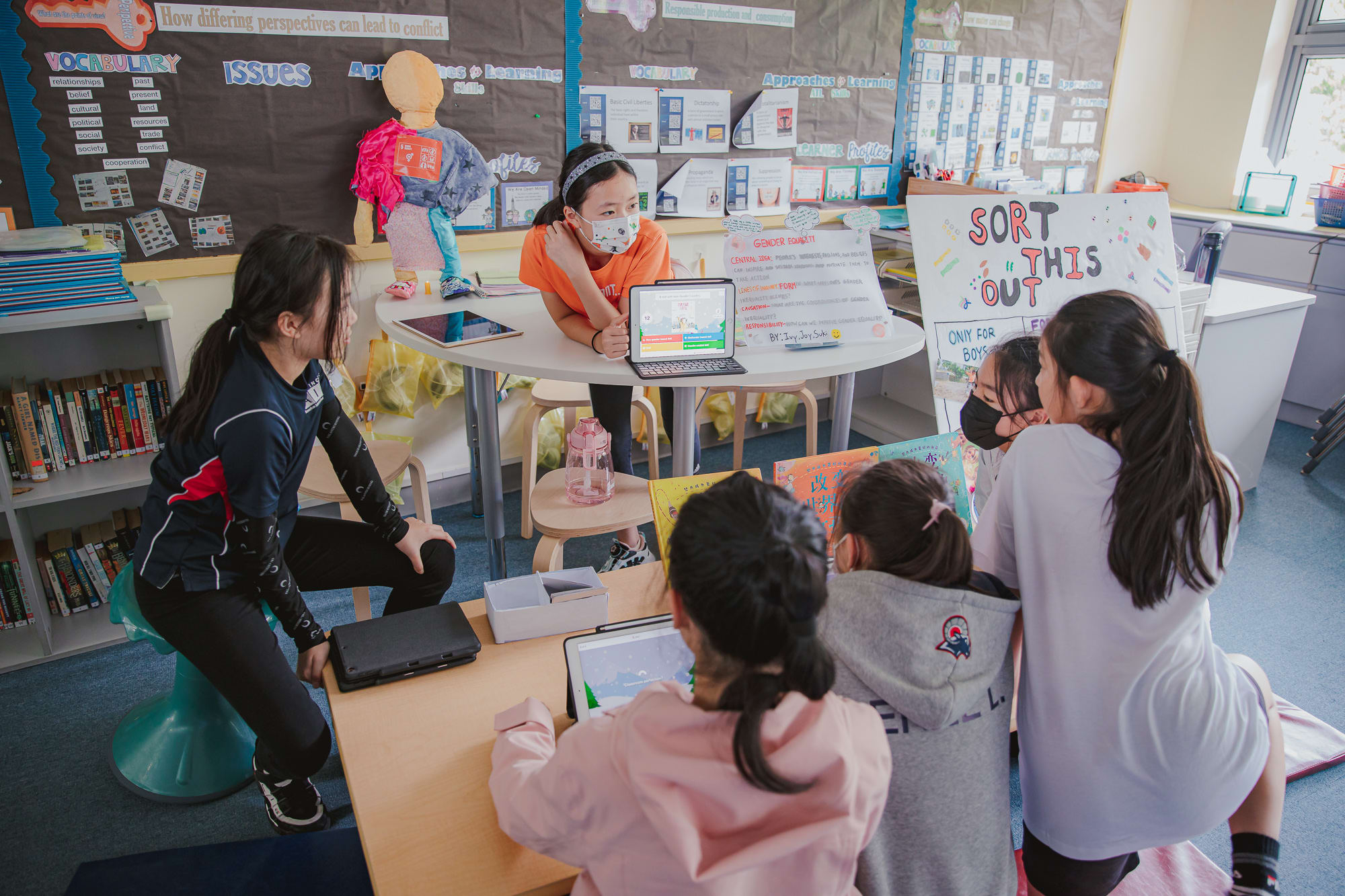 AISG PYP Exhibition with a student presenting to other elementary students