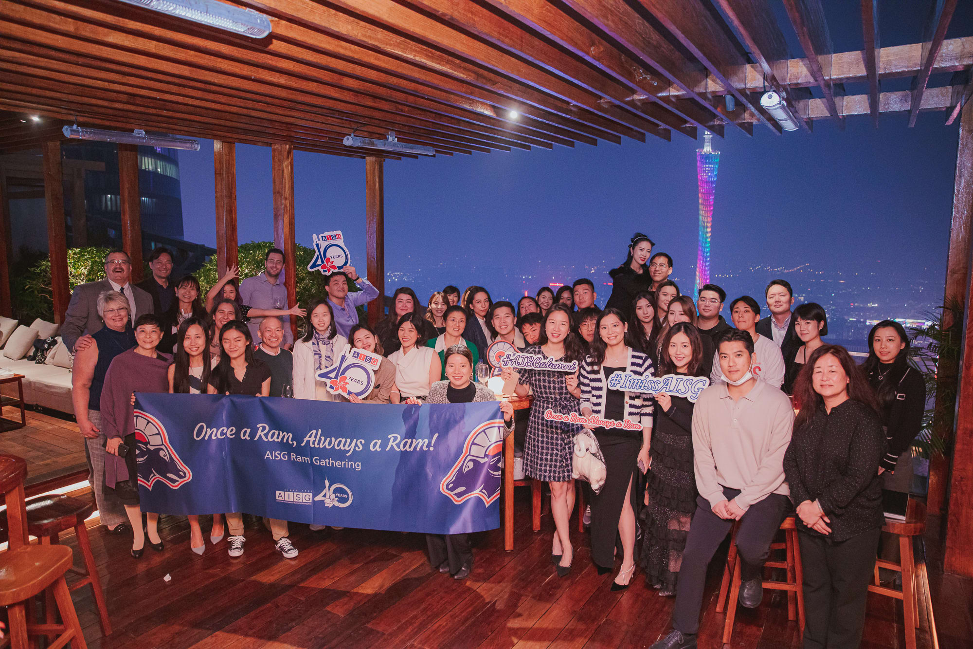 Group photo of everyone in the alumni Ram Gathering event with Canton Tower in the background