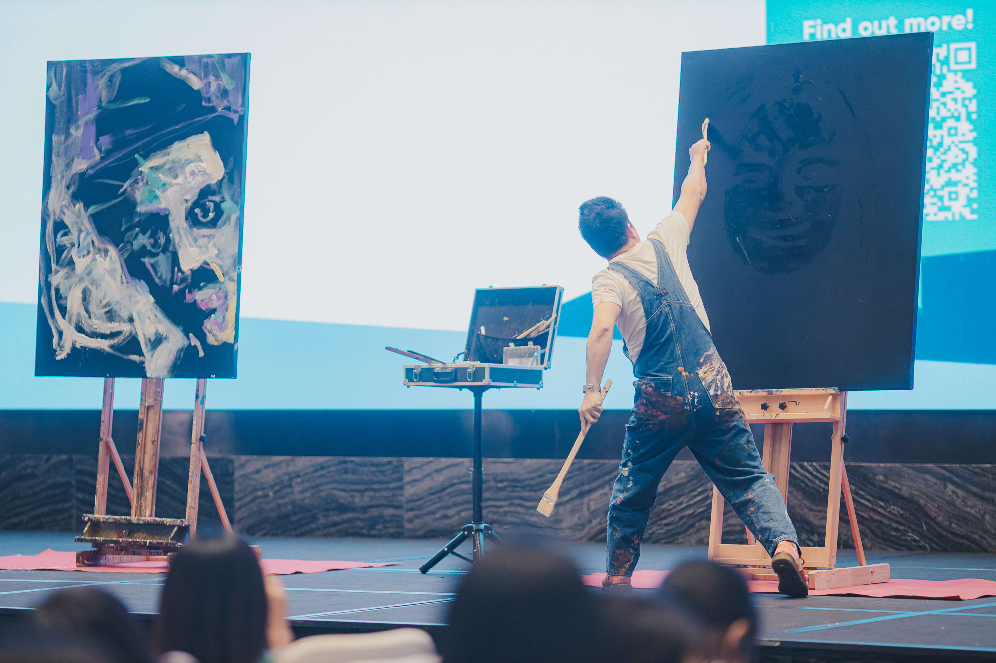 man painting on canvas