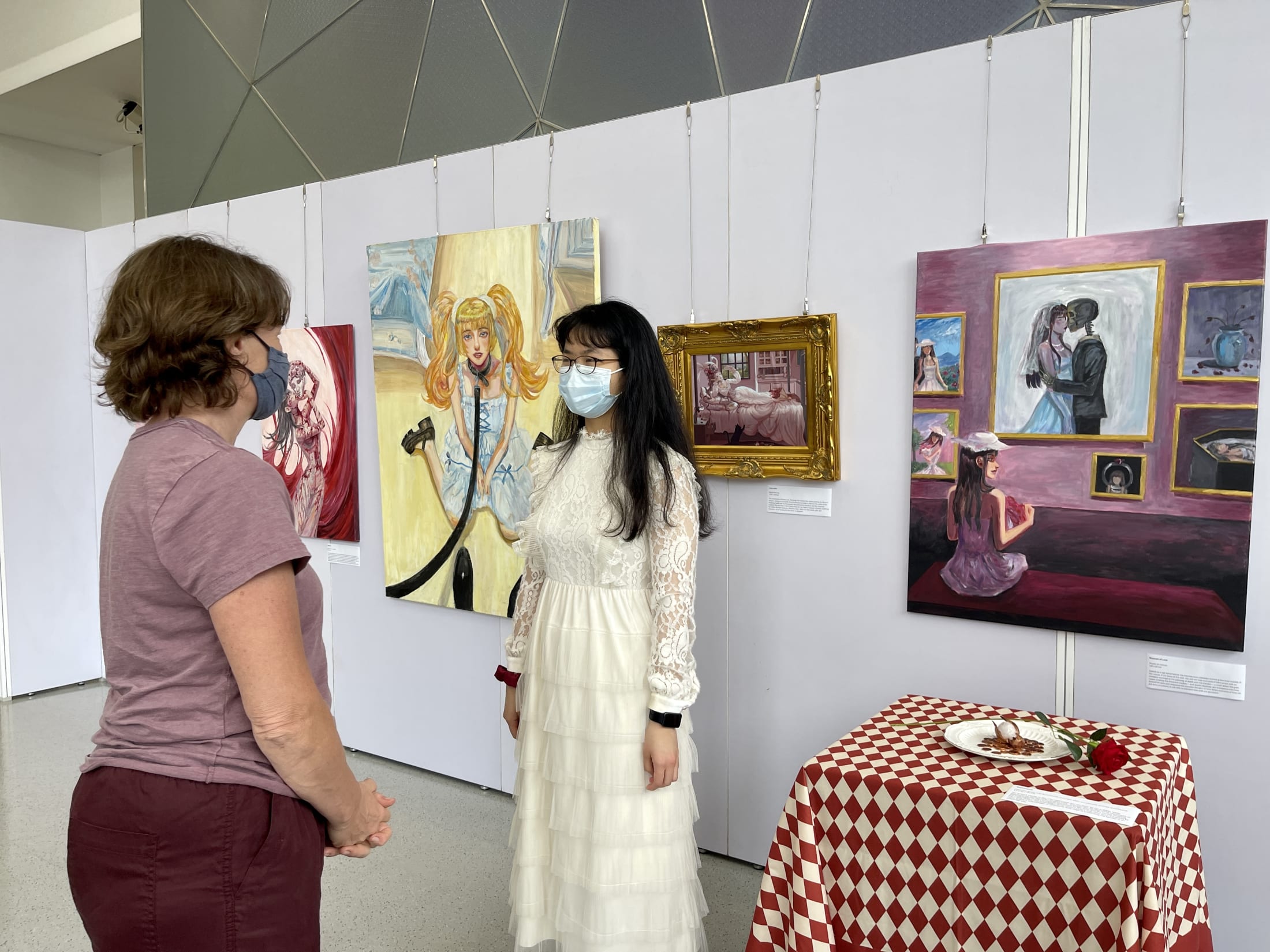 AISG IB Visual Art senior artist discussing her art with a teacher