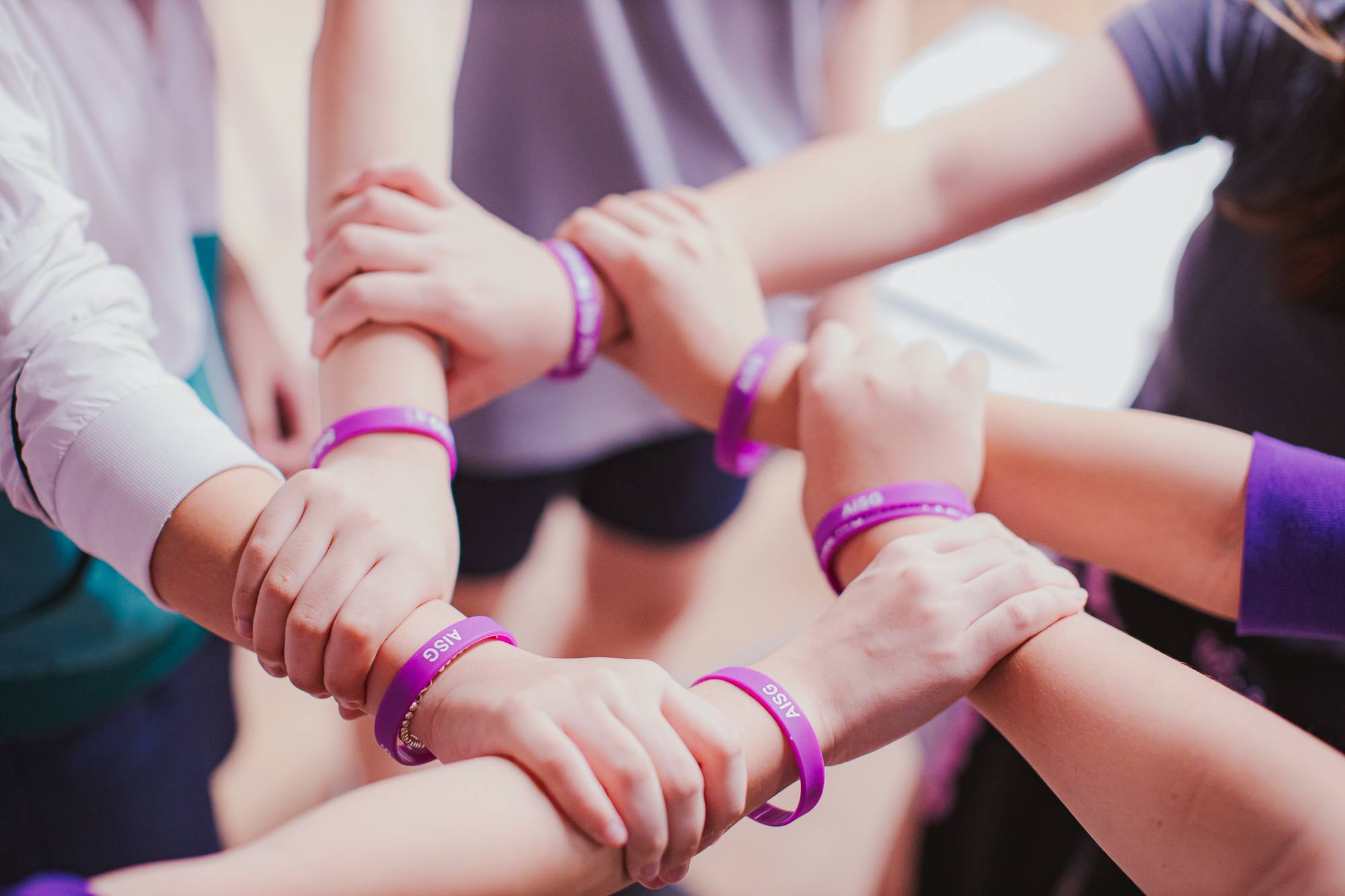 6 hands band in unity with AISG cares wrist band for AISG Child Protection Awareness Month