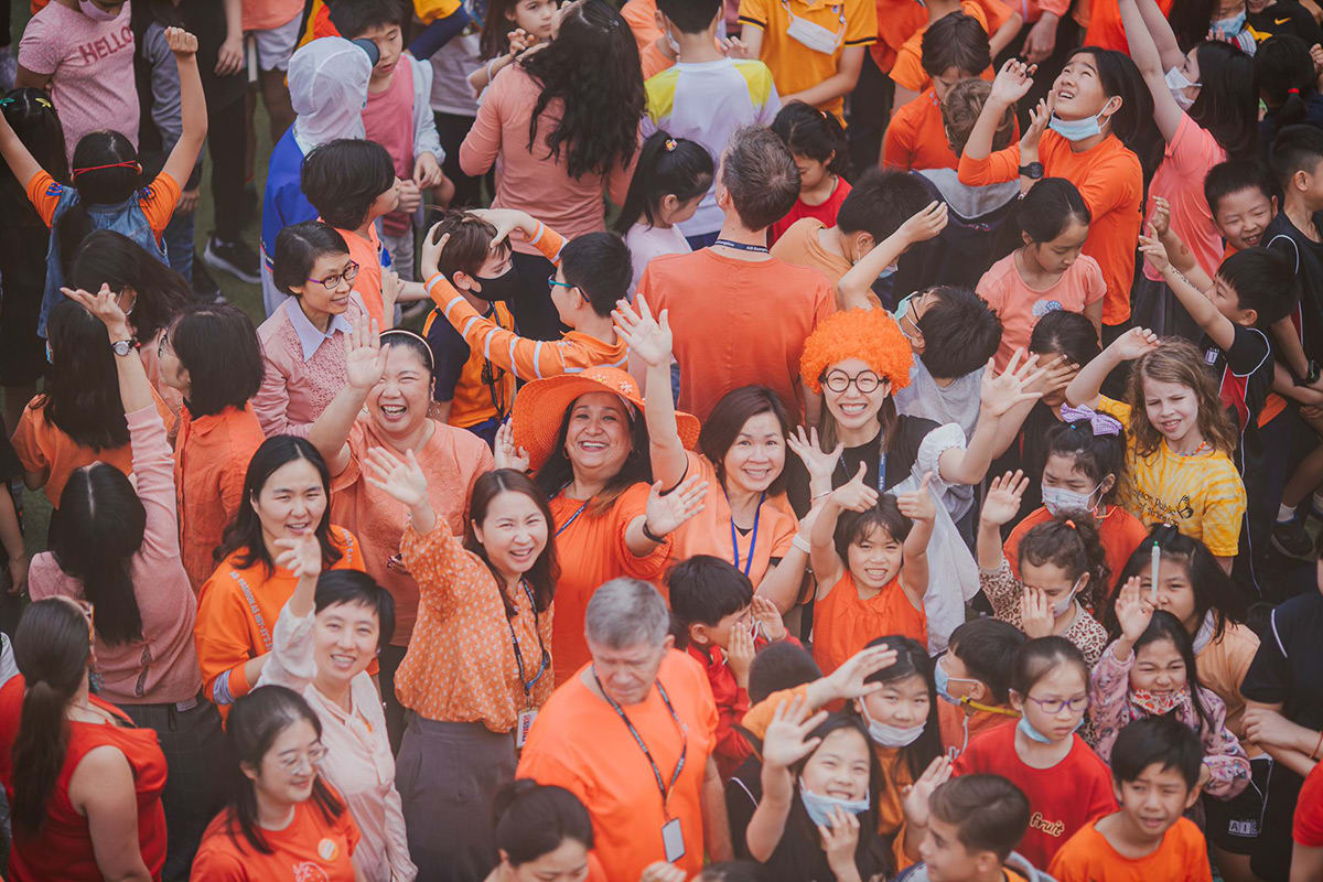 Teachers are waving at the camera