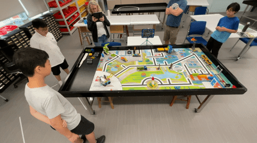 AISG FIRST LEGO League Competition with vehicles coded and moving in action