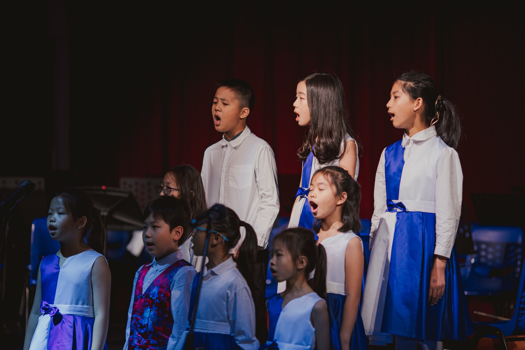 AISG elementary school students singing in a performance