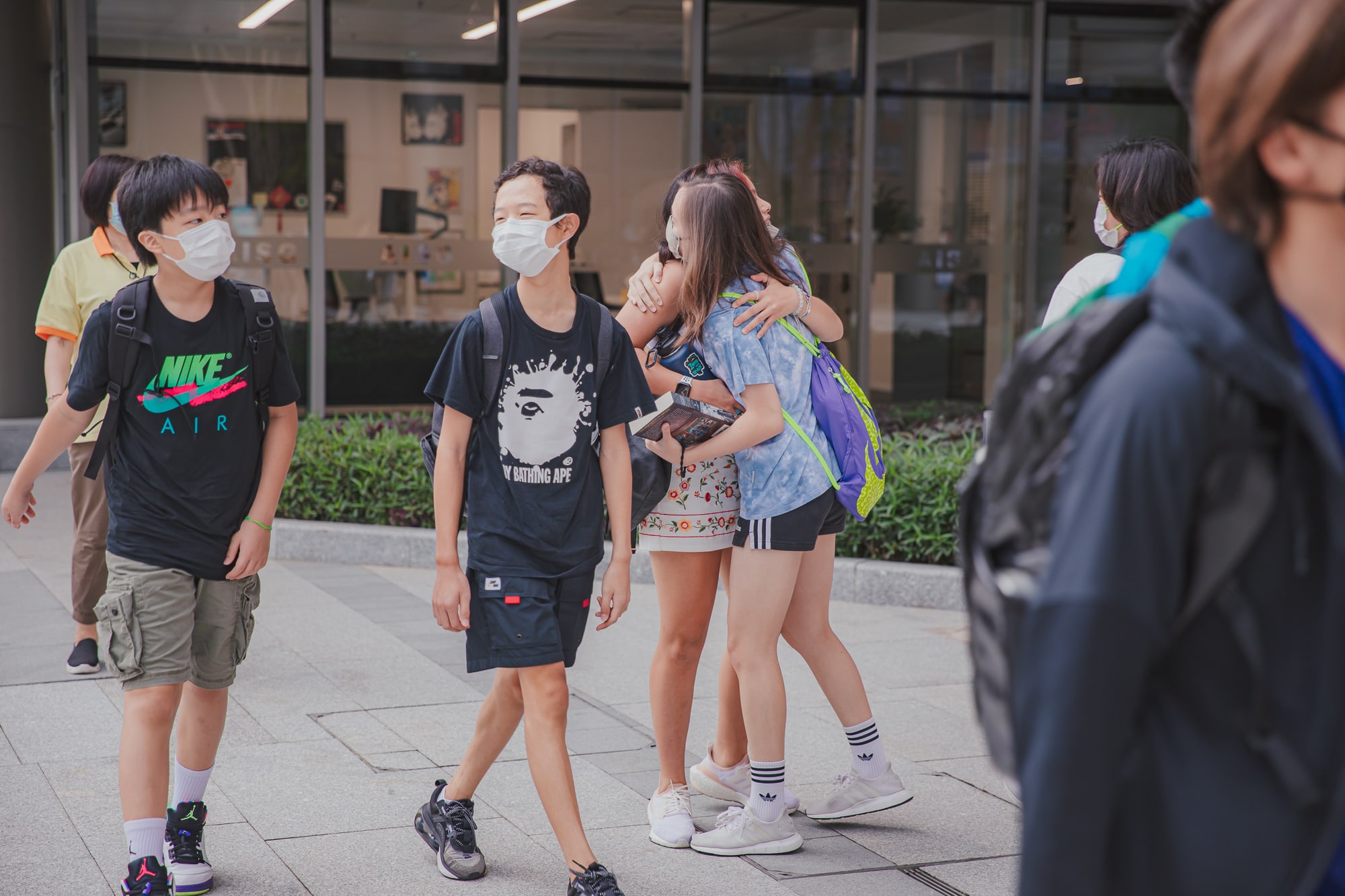 AISG students hugging reunion welcome back