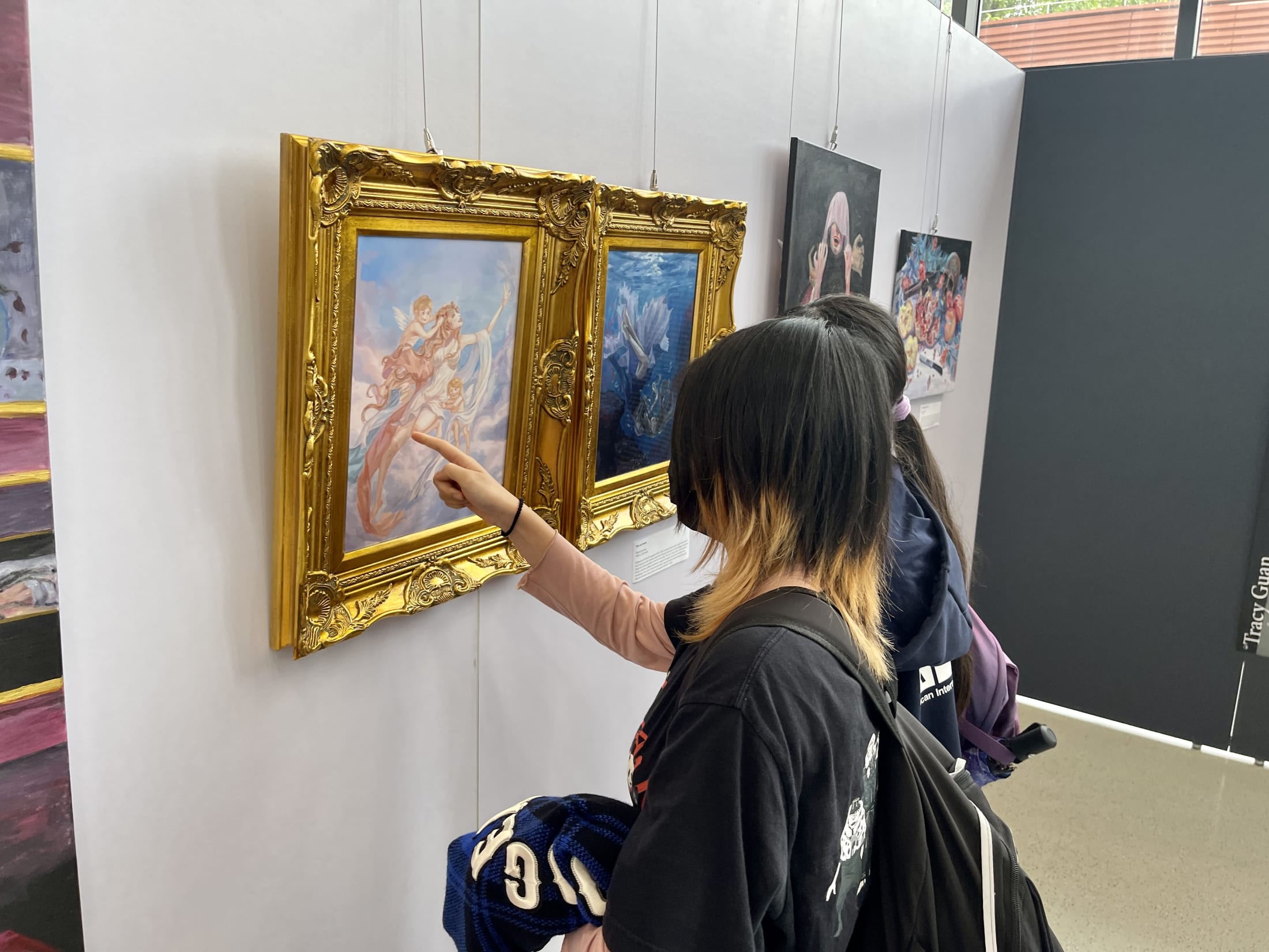 AISG IB Visual Art Exhibition with students discussing the art with each other