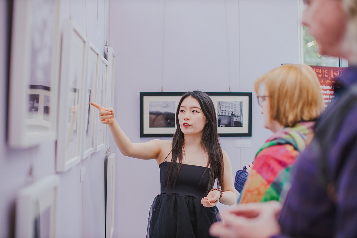 Student is introducing her work to audiences.