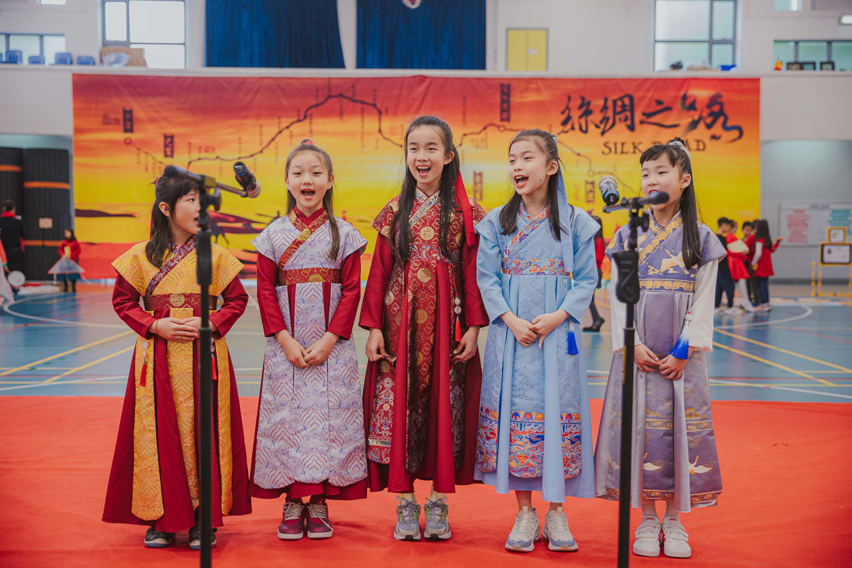 five girls singing in a performance at CNY