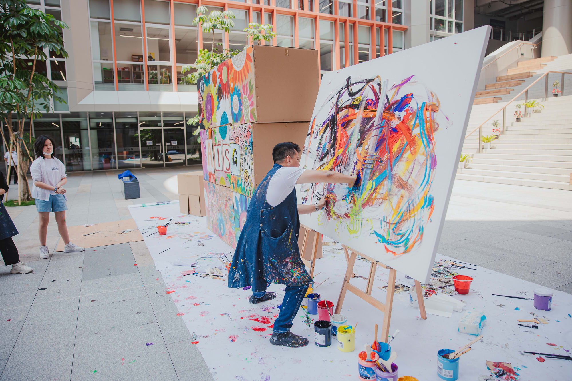 artist smearing paint on colorful canvas