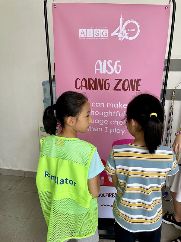 Picture of 2 elementary students as AISG Ramslators