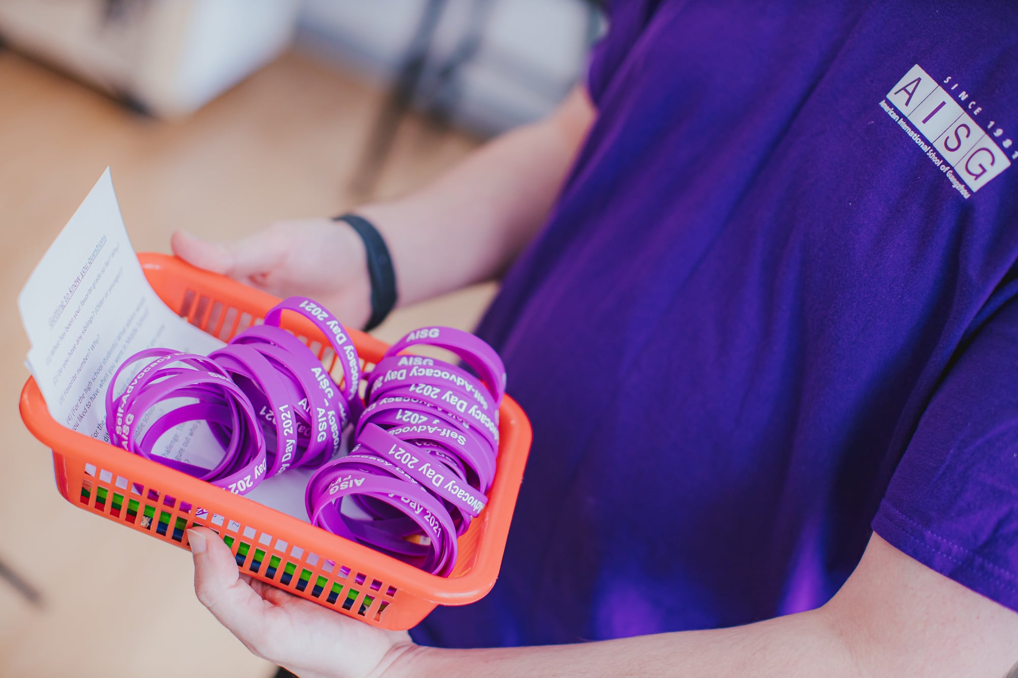 A basket full of AISG cares wrist bands for AISG Child Protection Awareness Month