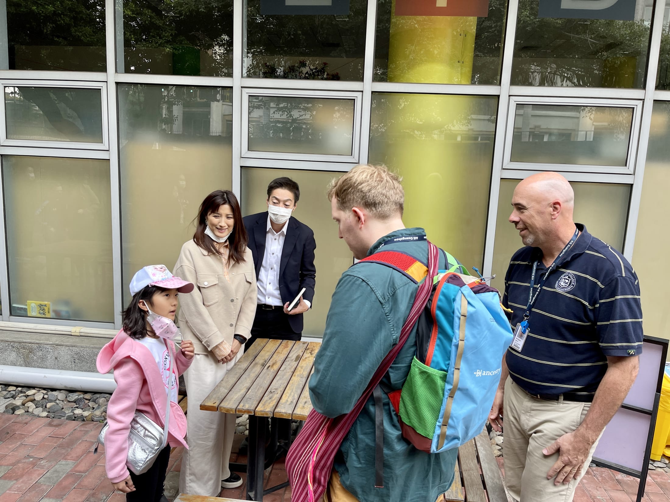 A new student and her family meet teachers at AISG's new families orientation