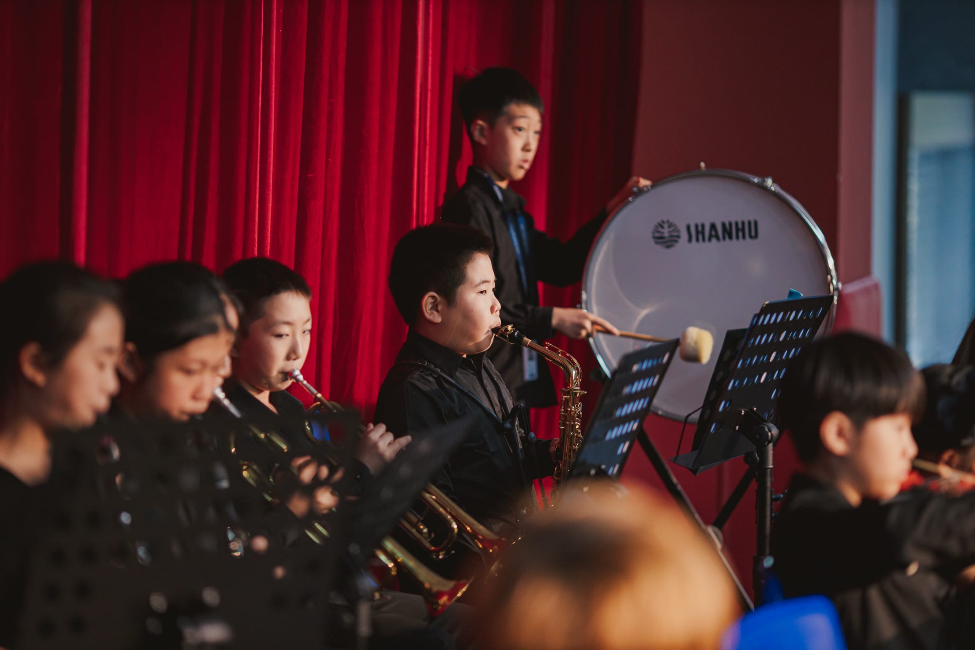 AISG elementary school students playing instruments in a performance