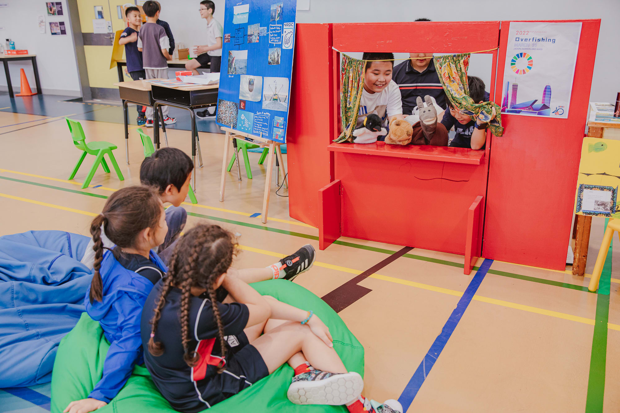 AISG PYP Exhbition with students using puppetry to explain Overfishing to 3 elementary students