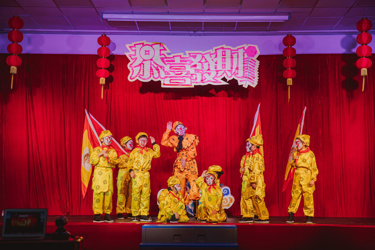 a group of students performing on stage during the chinese culture day celebration