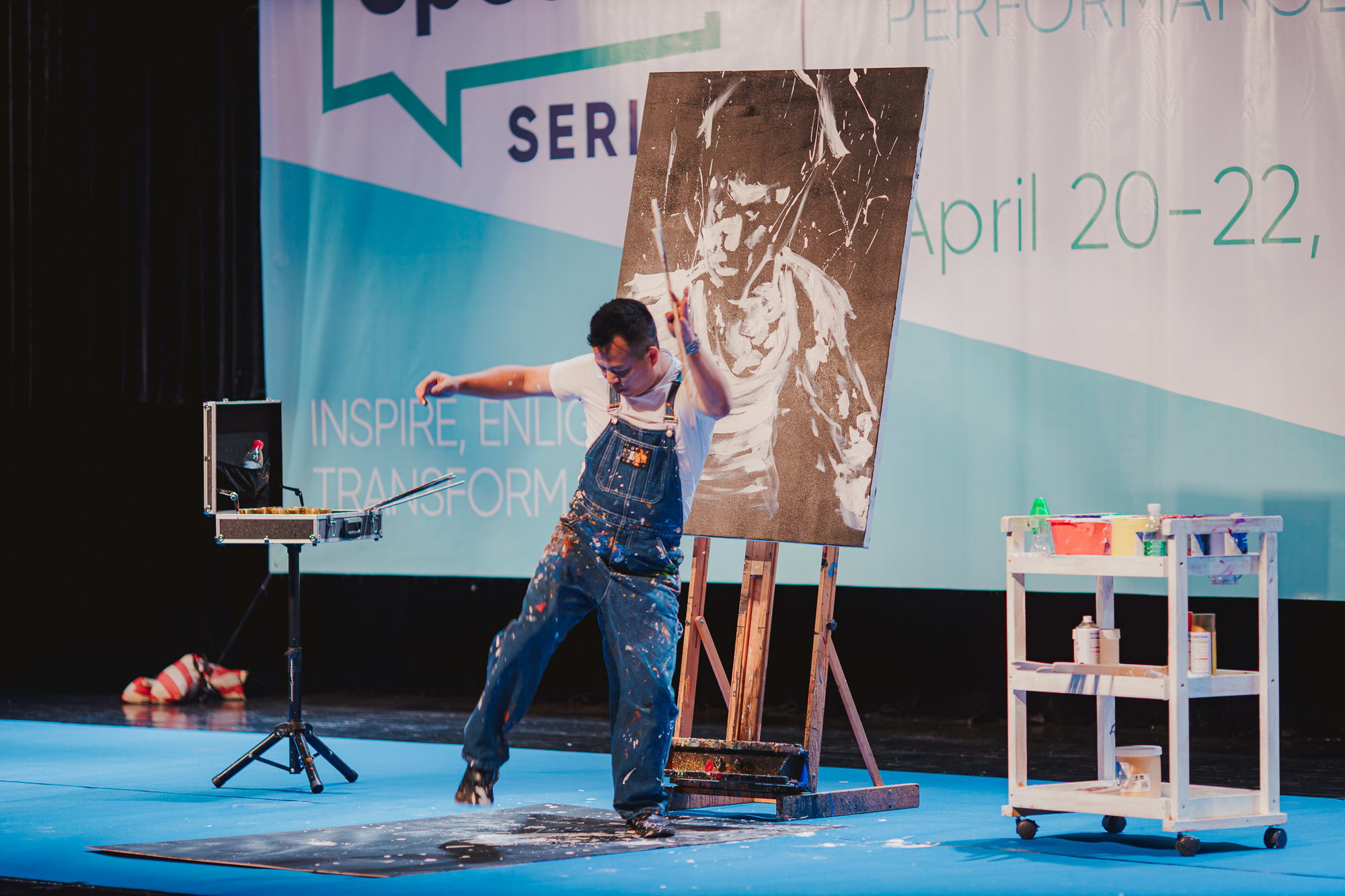artist performing onstage painting