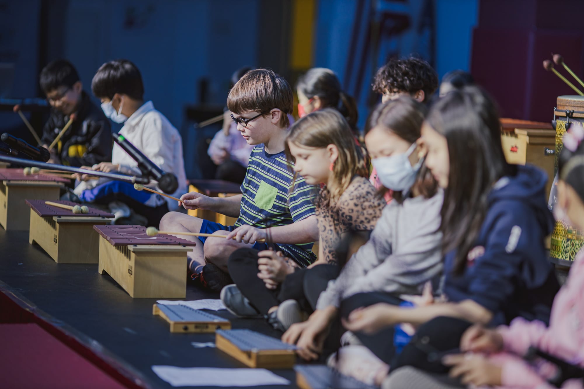AISG elementary school students playing instruments in a performance