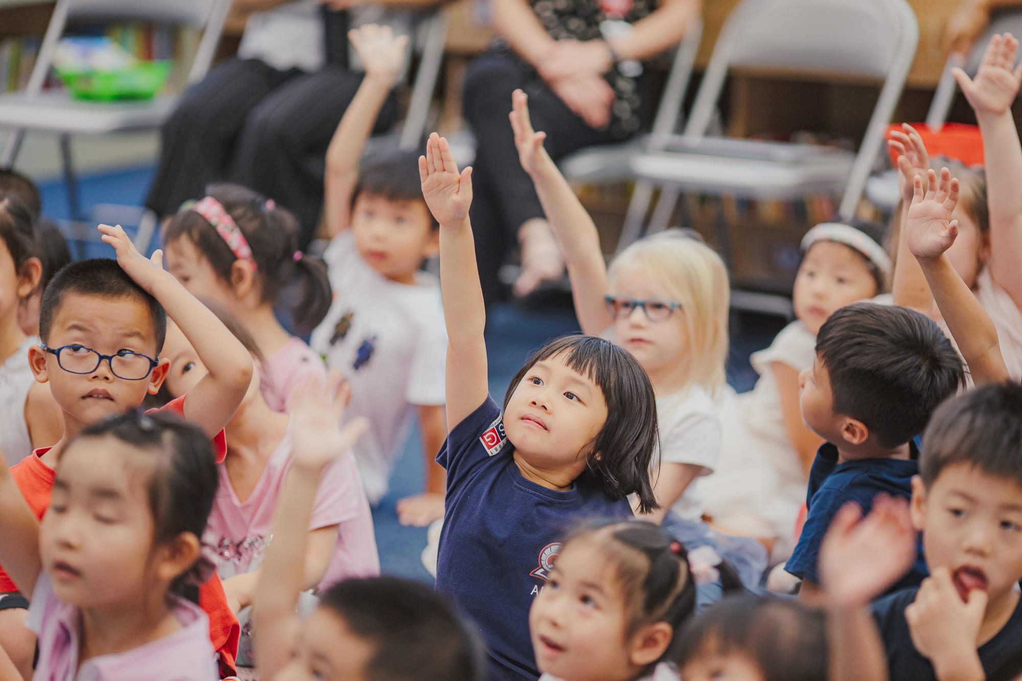 students raising their hands 